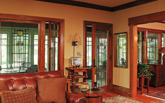 Art glass windows and full-view interior front door better connect the porch to the interior and bring more light into the living room.