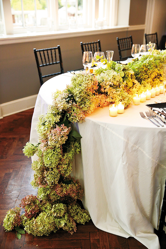 This hydrangea runner (designed by Martha’s Gardens) surrounded by candlelight served as a stunning focal point in the room.