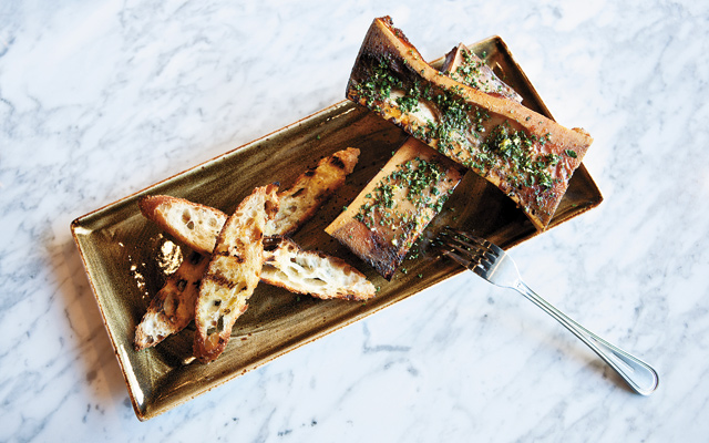 Good to the bone: Adventurous “foodies” can’t miss the Bone Marrow. Huge cow bones with their marrow are a smokey surprise, covered in a gremolata of parsley, garlic, lemon zest, and salt. Smear it on toasted bread and share! Photo by Hubert Bonnet
