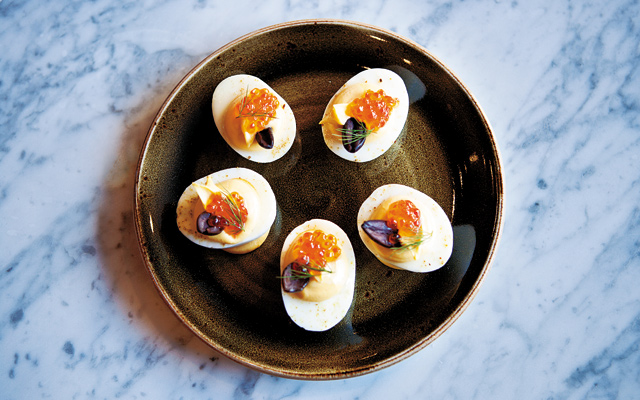Not your Grandma’s recipe: Another tasty bite is the Deviled Eggs. The eggs are accompanied by smoked caviar-tasting trout eggs hit with a touch of cumin salt and a dash of lemon and dill. Photo by Hubert Bonnet
