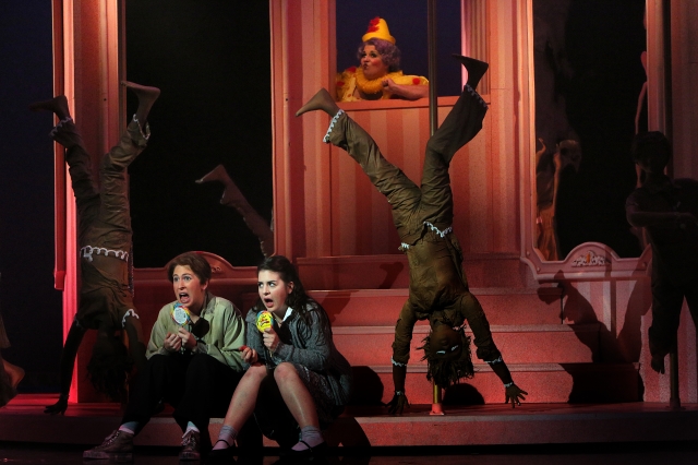 Hansel and Gretel (Stephanie Lauricella and Angela Mortellaro) enjoy treats while the witch (Marianne Cornetti) looks on. Photo by Michal Daniel