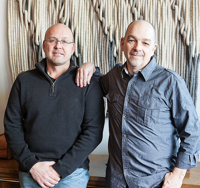 Jon Mehus (left) and Neal Kielar (right) take a moment to smile between sharing stories about the furniture at MidModMen+friends. Photo by Hubert Bonnet