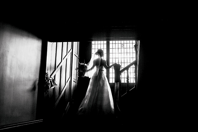 “Alisa” dress ($4350) by YolanCris, Austen Belt ($750) by Johanna Johnson, vintage accessories, and custom veil (pricing available upon request) from The White Room. Photography by Matt Lien Photography