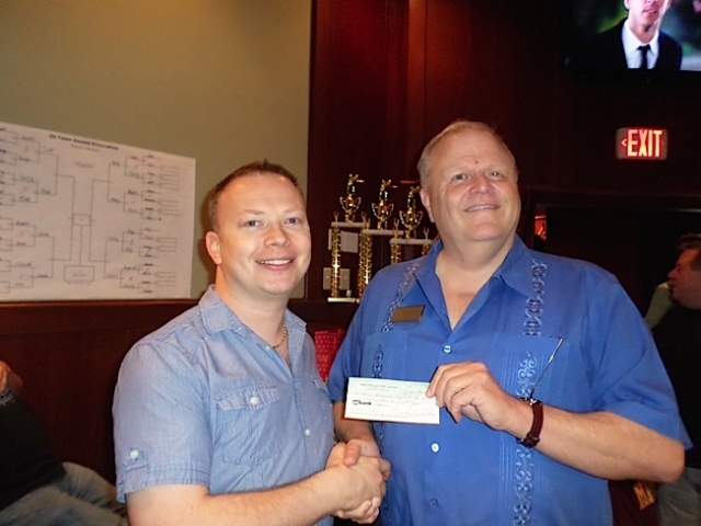 TCGPL Treasurer Brant Vlasak (left) presented a check for $1,500 to The Aliveness Project Food Shelf, represented by Tim Marburger, Director of Fundraising and Special Events. Photo by George Holdgrafer.