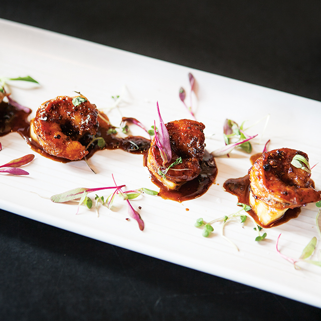 Black pepper shrimp are an unexpected pop of flavor with pickled pineapple, ginger, and black bean sauce. Photo by Hubert Bonnet