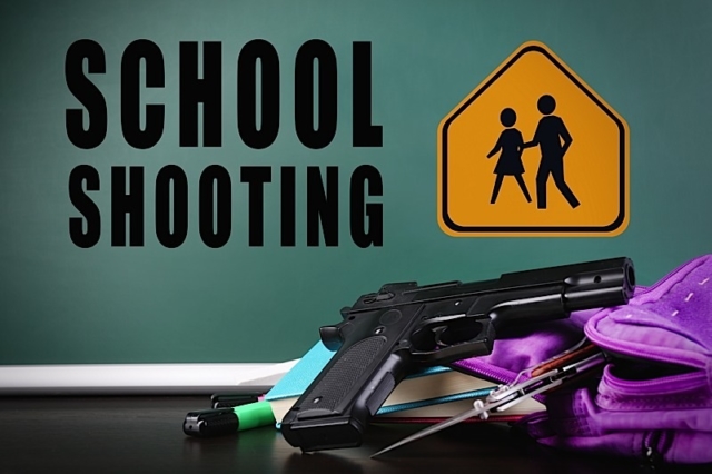 Backpack with gun and knife on table against blackboard. School shooting concept Photo courtesy of BigStock/Yastremska