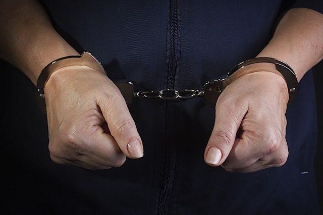 Prisoner Woman With Handcuffs In Her Arms Prisoner woman with handcuffs in her arms