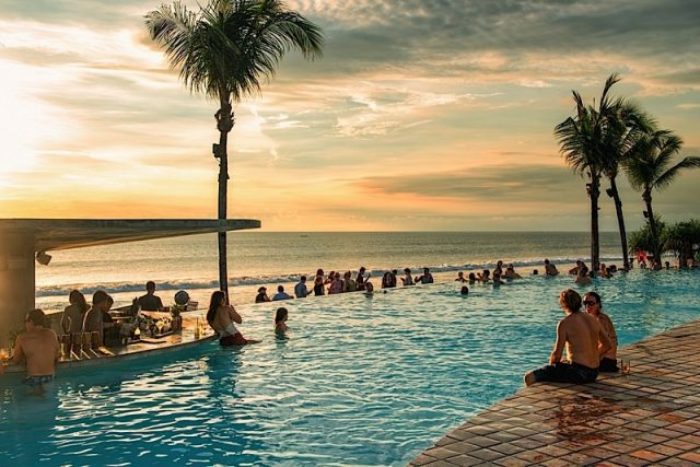 Bali, Indonesia - February 4, 2013: Tourists Enjoy A Bali Vacation By The Pool And Beach. Bali Is Po Photo courtesy of BigStock/Rolf_52
