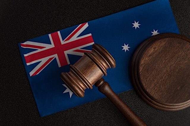 Judge Gavel On Australian Flag. Court In Australia. Australian Auction. Photo courtesy of BigStock/SomeMeans