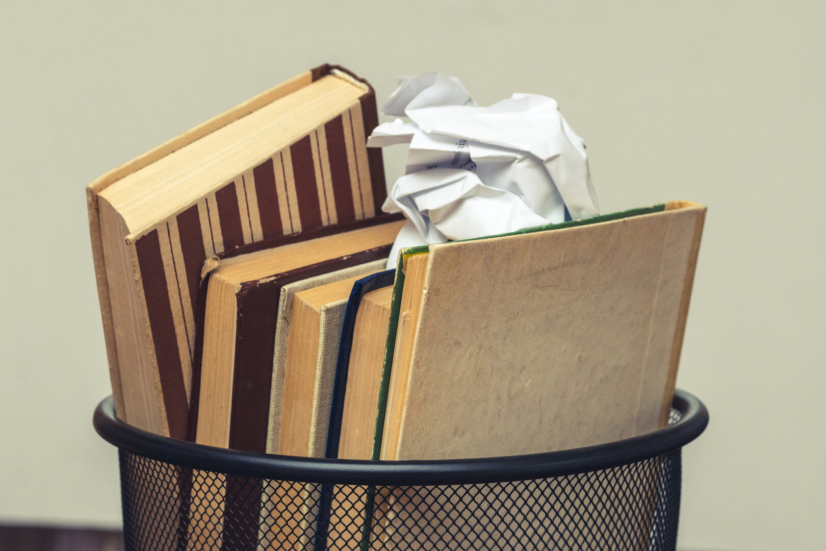 Books thrown away in garbage bin.
