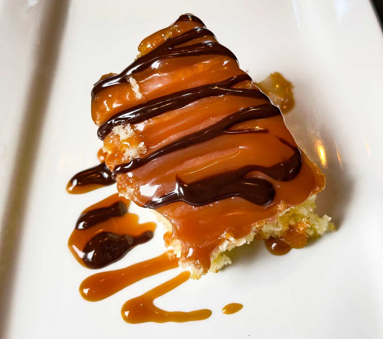 Slice of Kentucky Butter Cake drizzled with chocolate.