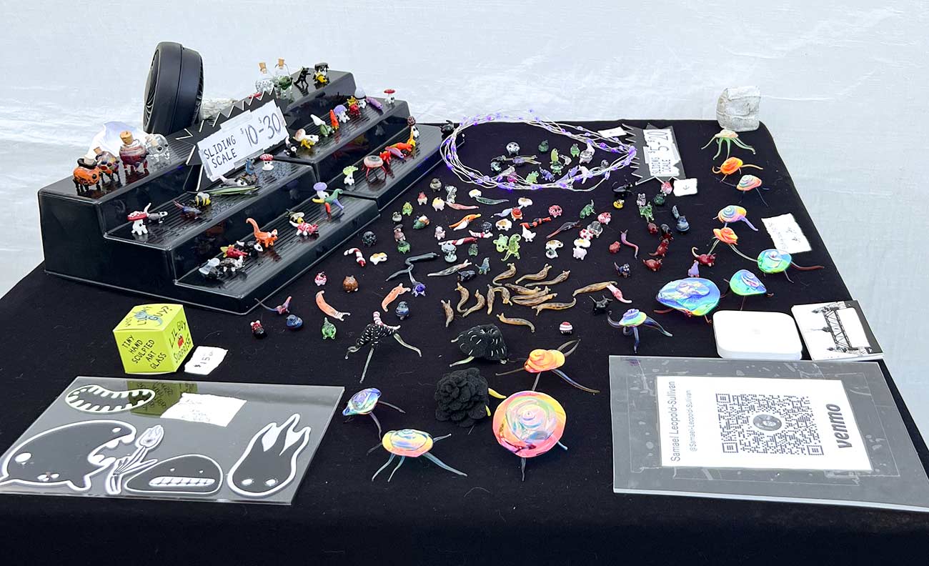 Samael Leopold-Sullivan displays miniature figurines at the Powderhorn Art Fair.