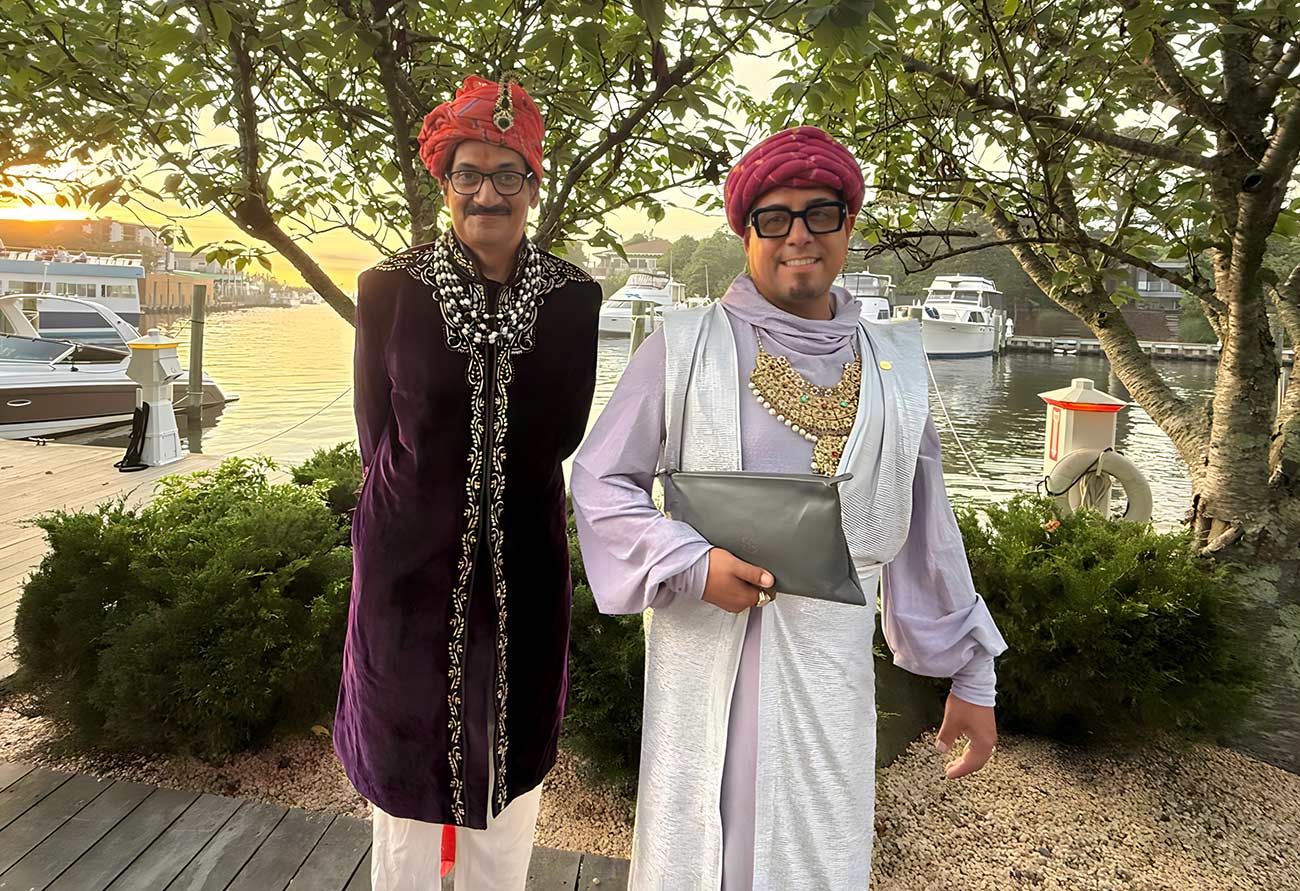 HRH Prince Manvendra Singh Gohil & HH Prince DeAndre standing by the waterfront.
