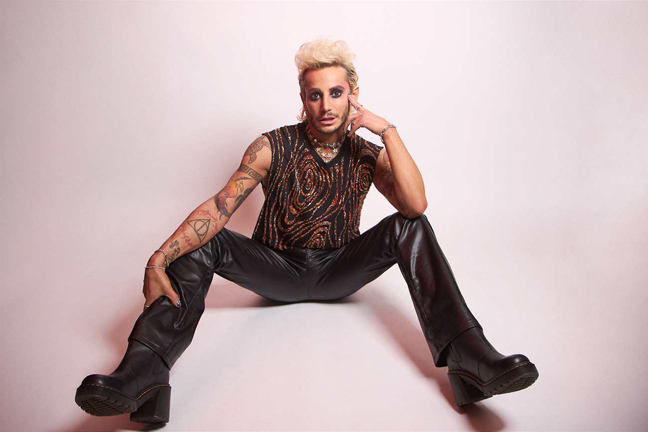 Frankie Grande poses sitting down for a promotion photo.