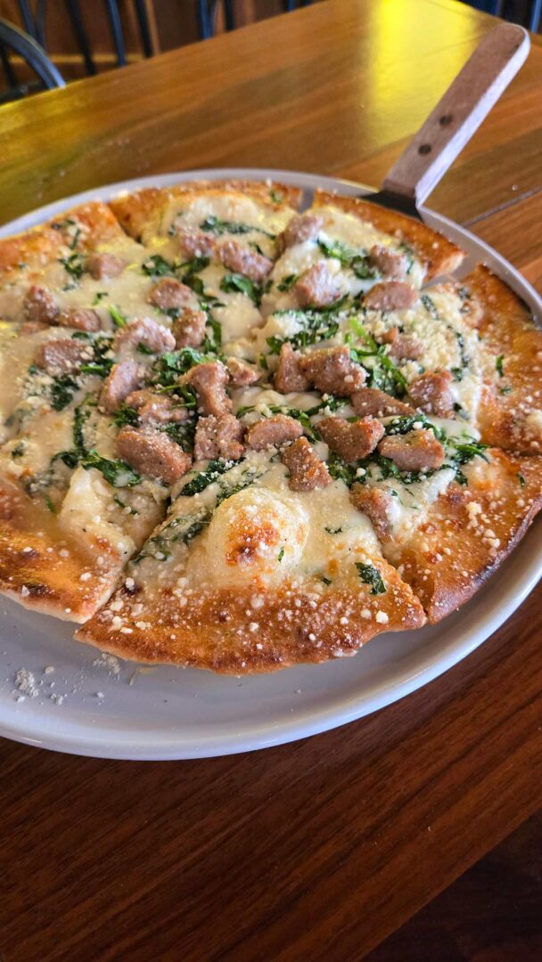Pizza pan with a white pizza at Empire Kitchen & Cocktails.