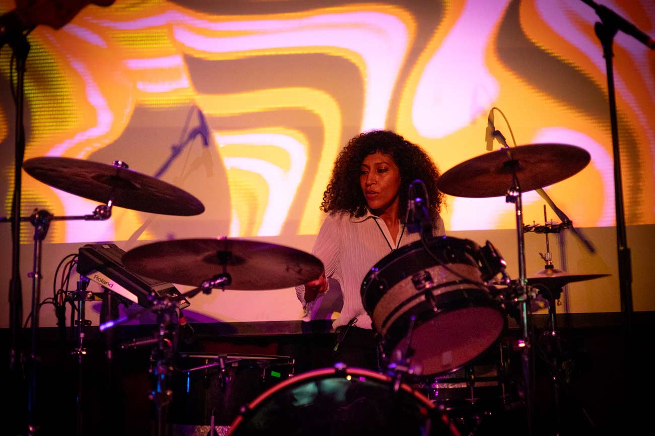 Band performer Audrey Johnson of La Luz on stage playing the drums.