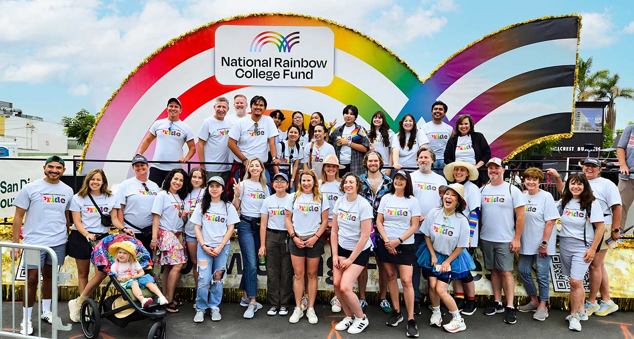 Group shot of members of the National Rainbow College Fund in front of their parade float.