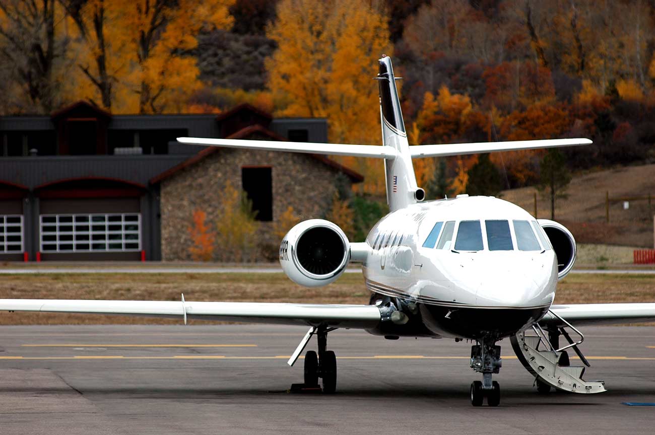 Private jet on tarmac ready for passenger boarding.