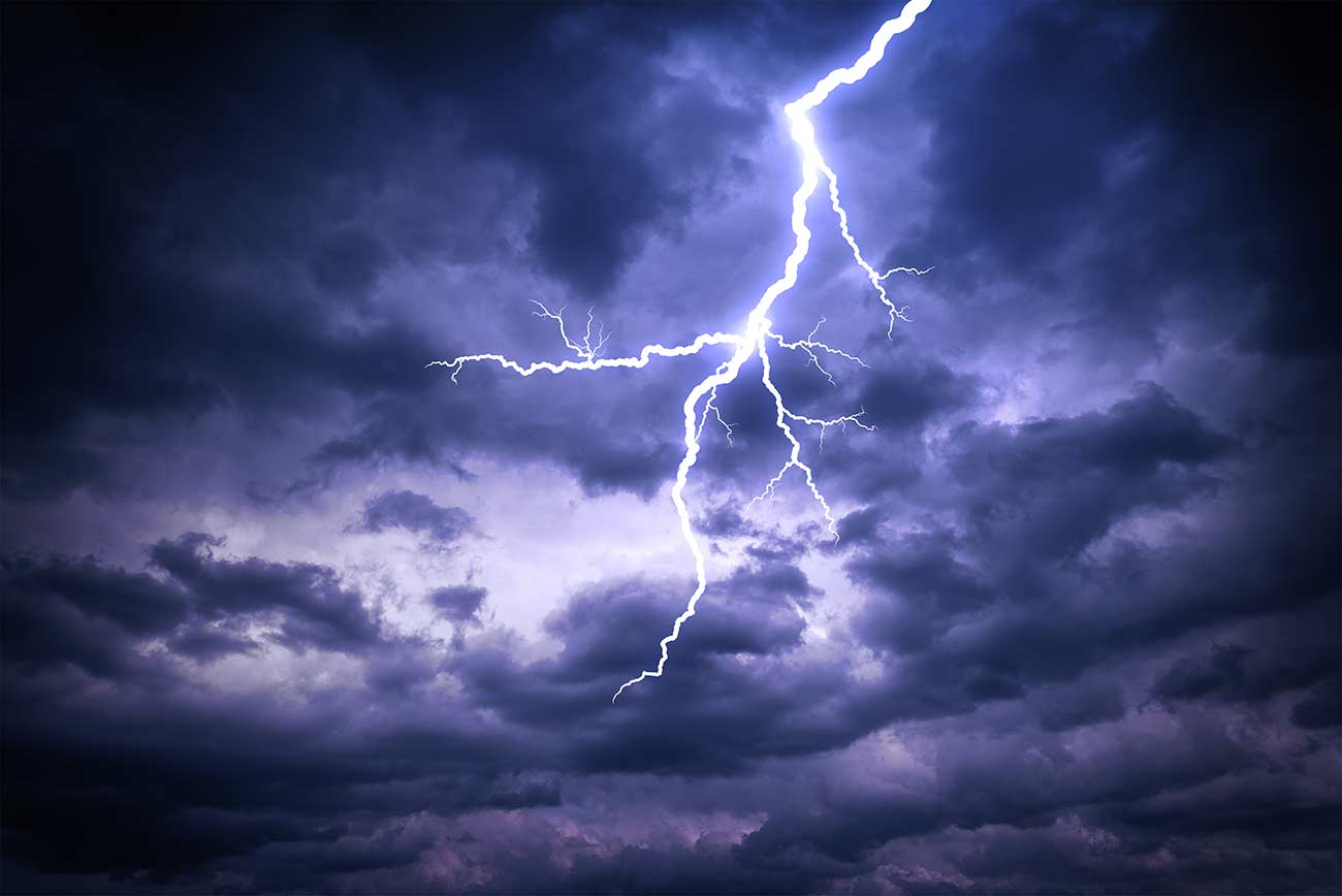 Lightning strike on the dark cloudy sky.
