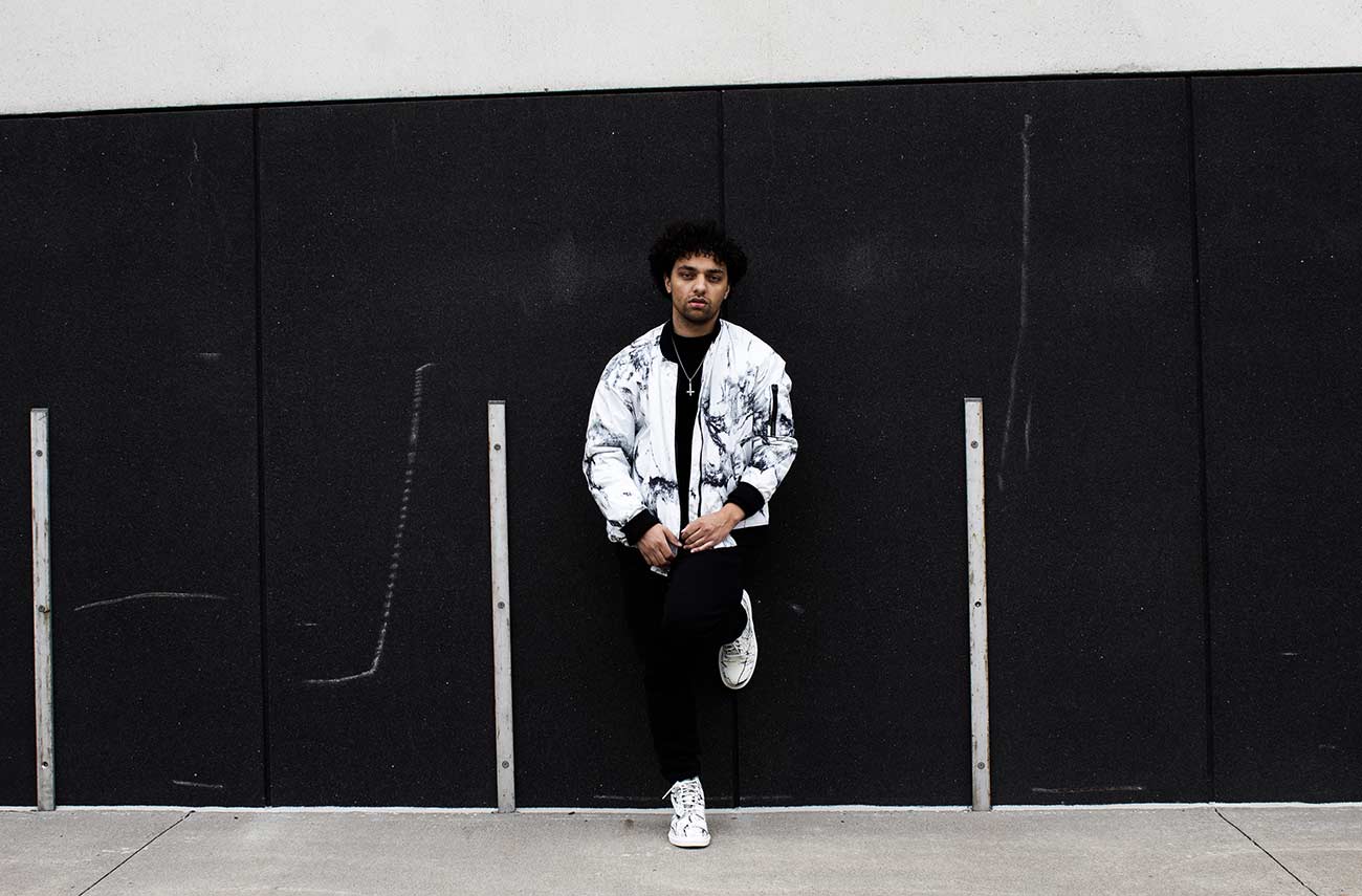 Music artist posing for a promotional photo.