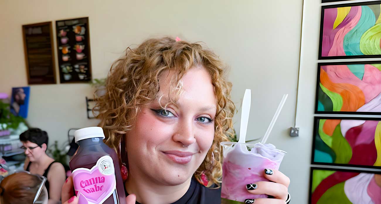 Young woman holding a bottle of Canna Babe and a cup of soft serve ice cream.