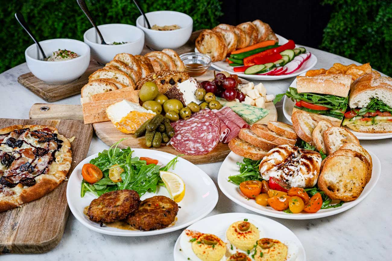 Table featuring several different food dishes at Milly’s Wine Bar & Bistro.