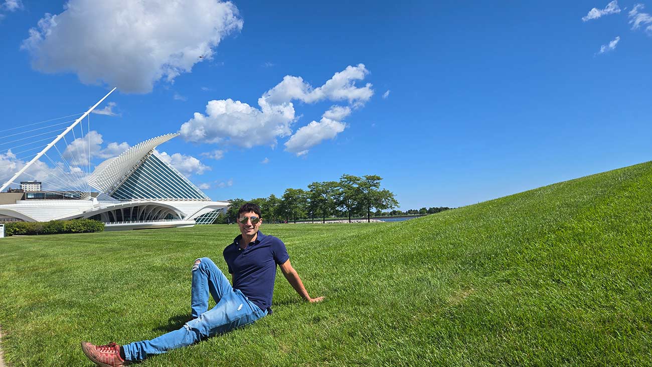 Joey sitting in the grass outside of the Milwaukee Art Museum.