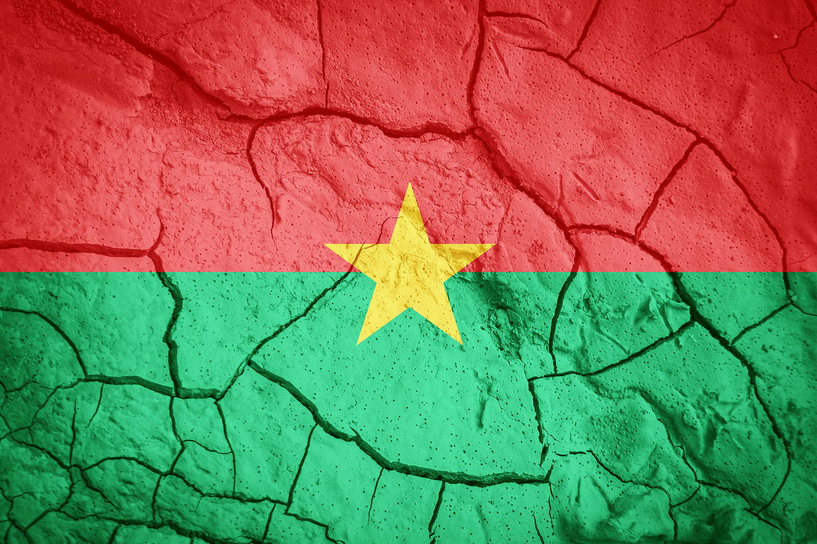 Flag of Burkina Faso on a cracked and peeling wall.
