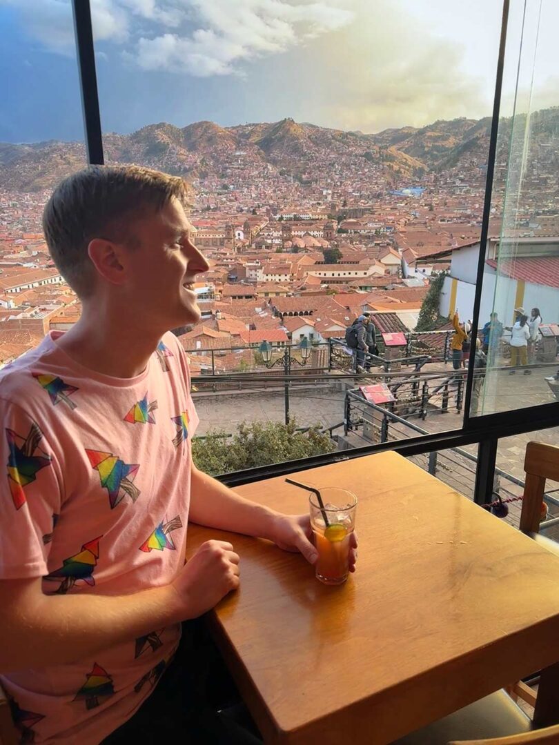 Mikah enjoying a cocktail overlooking Cusco at Sunset.