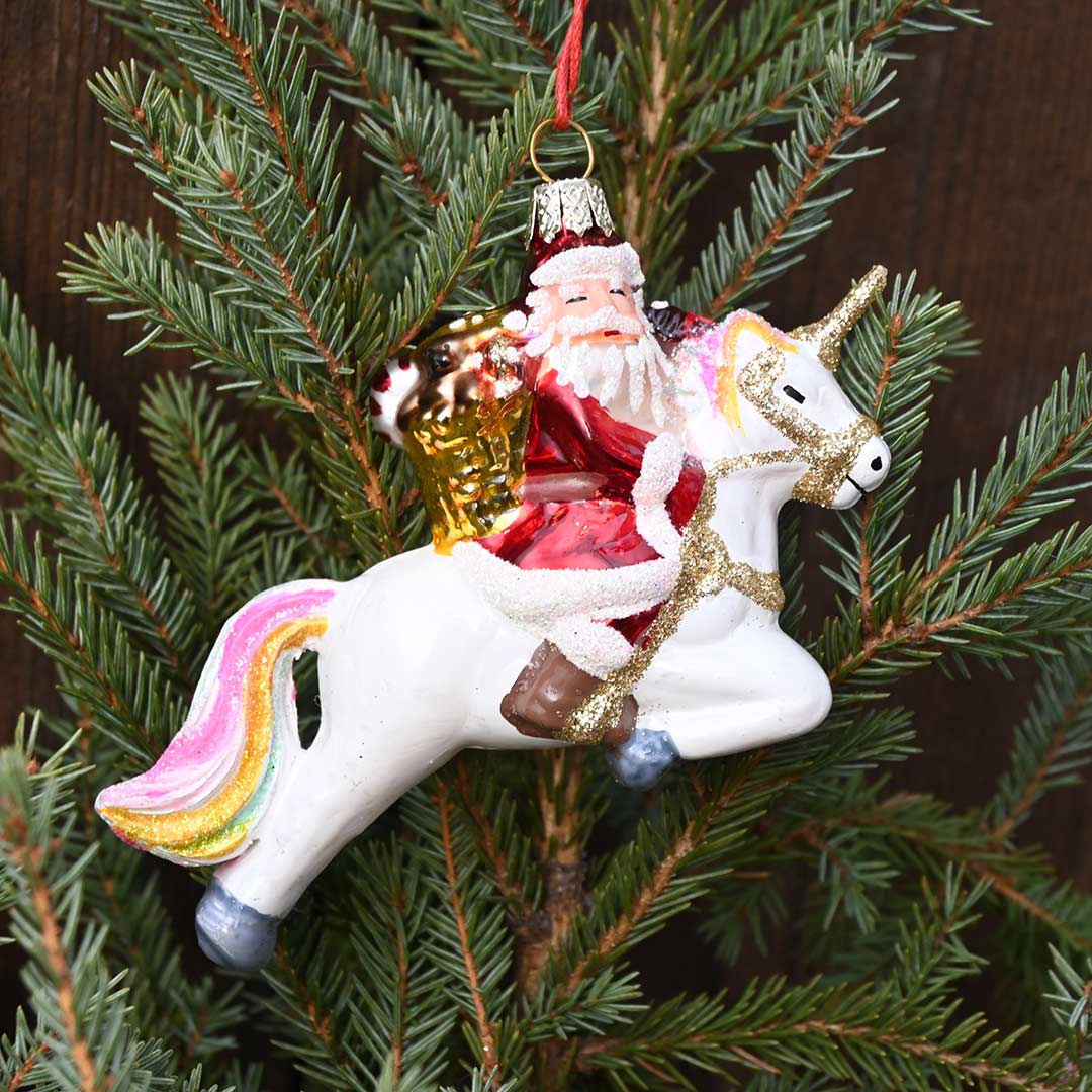 Ornament featuring Santa riding a Unicorn.