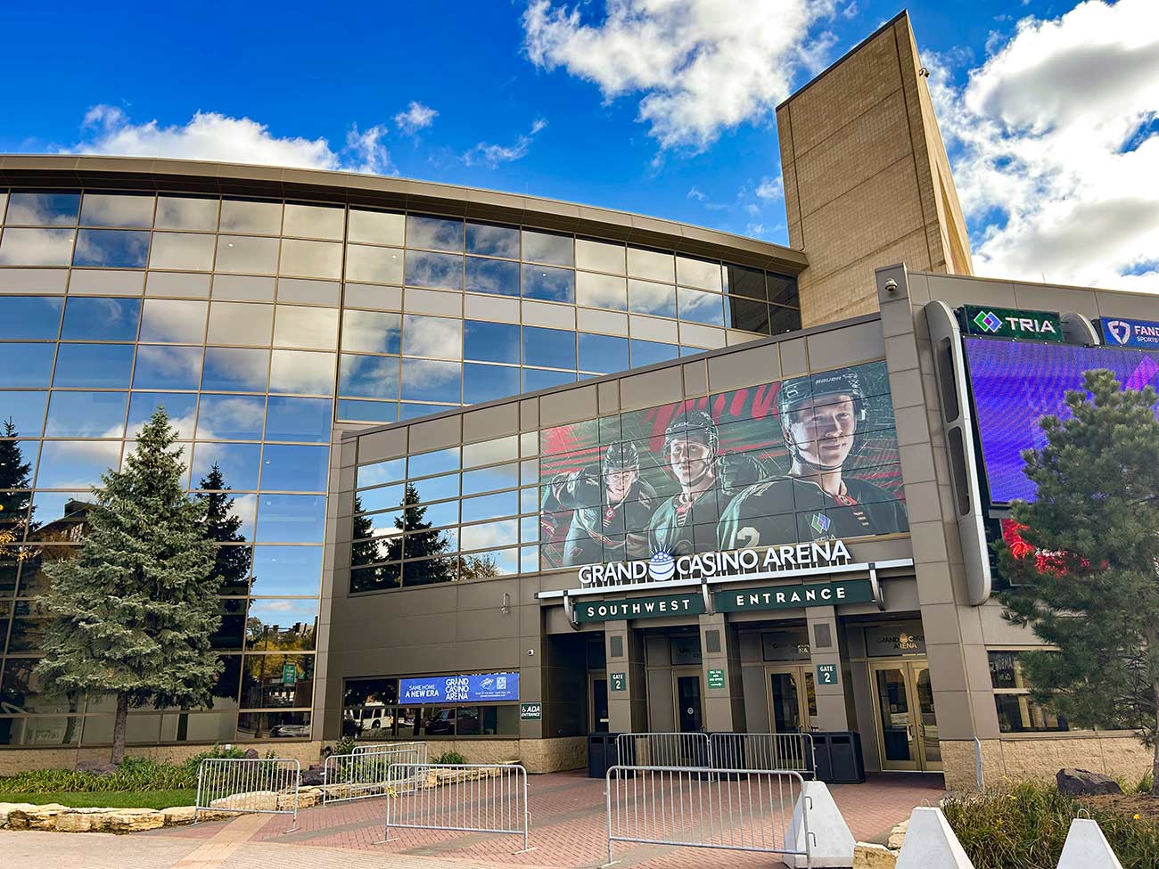 Exterior view of the Grand Casino Arena featuring MN Frost hockey players on the LED screen.