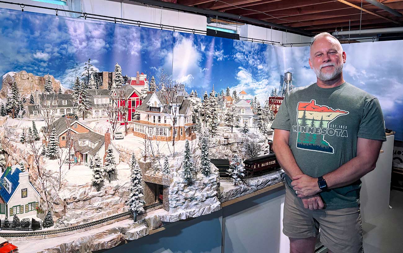 Jeff Junkins standing in front of his Christmas Village display.