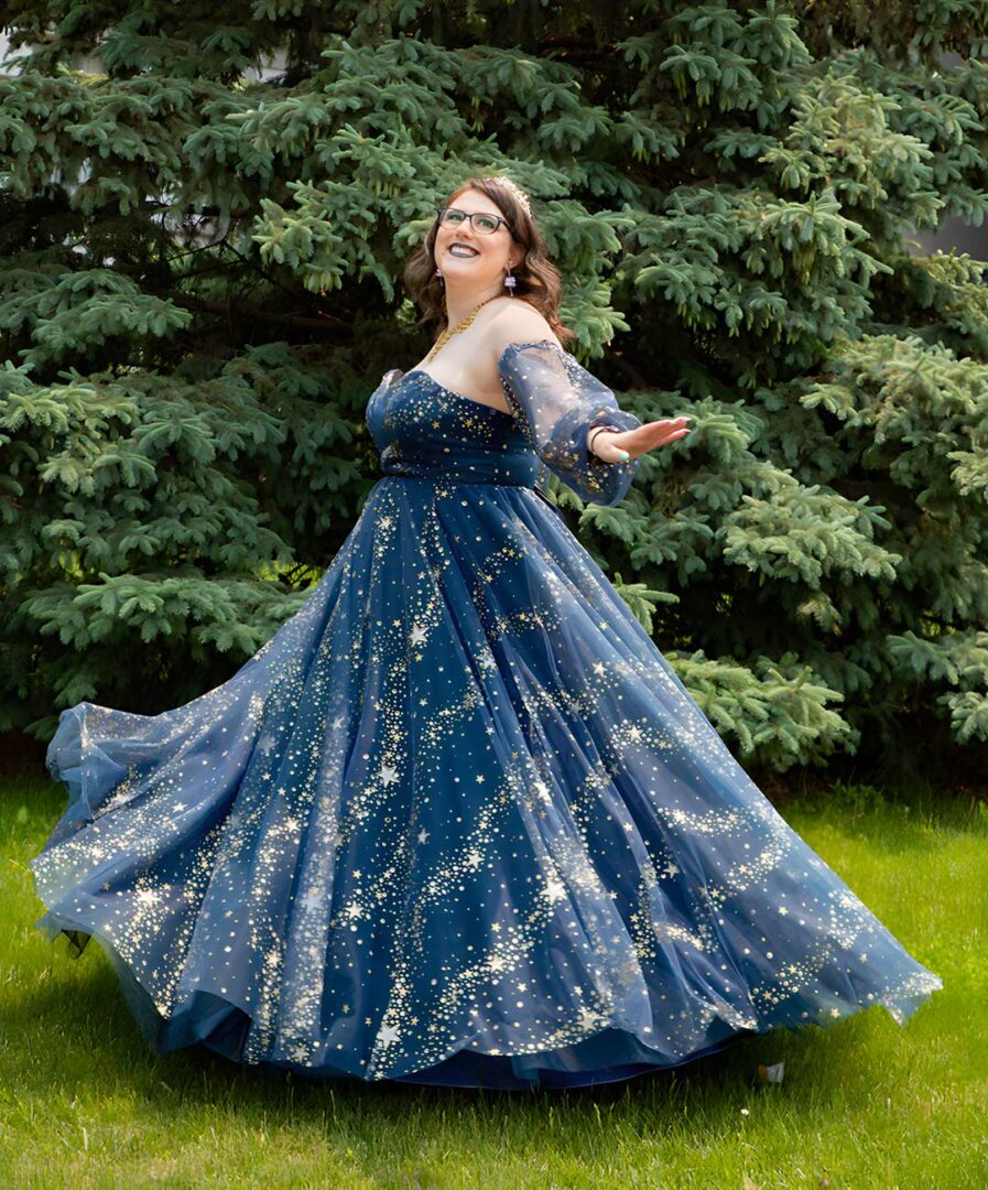 Rachel wearing a moon and stars flowing dress in a park.