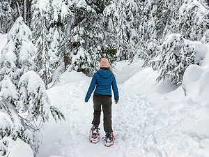 A young woman snowshoeing.