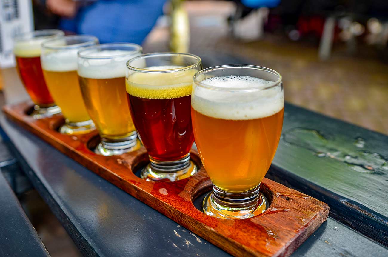 Craft beer tasting: five glasses with beers of different colors and flavors.