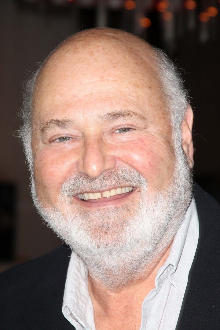 A photo of a smiling Rob Reiner at a Hollywood event.