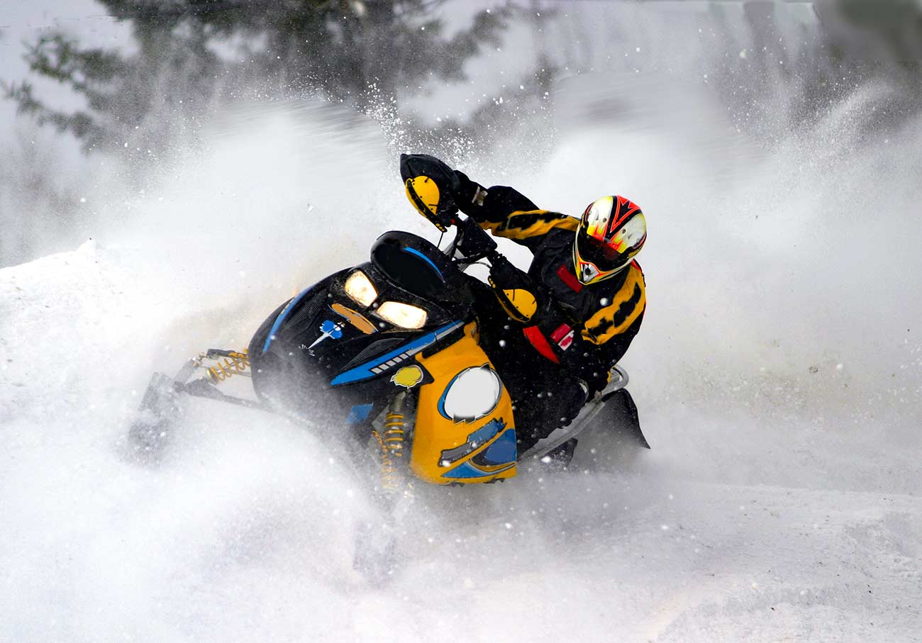 Snowmobiler during a snowcross cloudy overcast day.