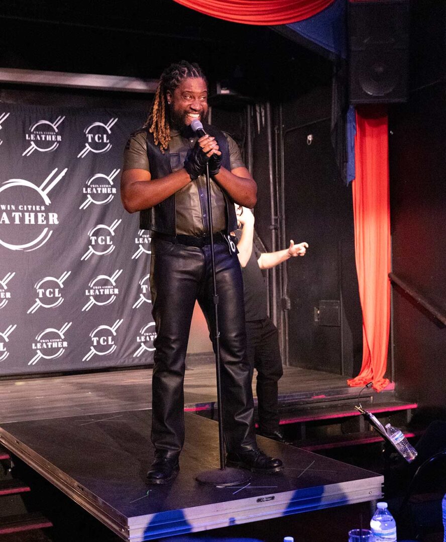 Denzel Belin giving a speech on stage.