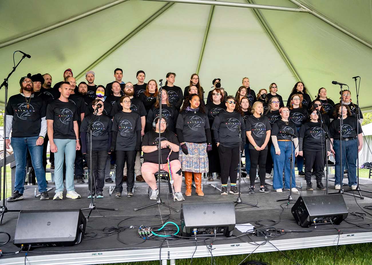 Group shot of the Rochester Rainbow Choir on stage.