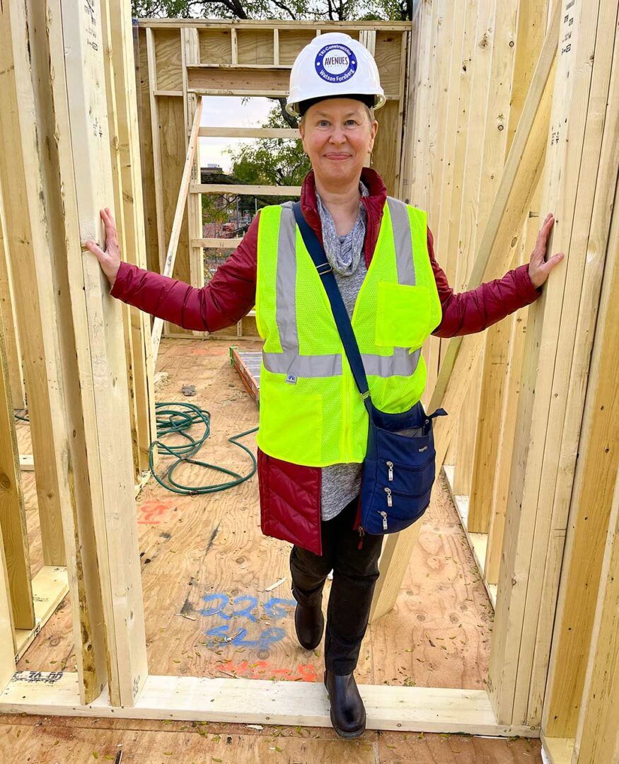 Katherine Meerse on the construction site standing in the door frame of a bedroom.