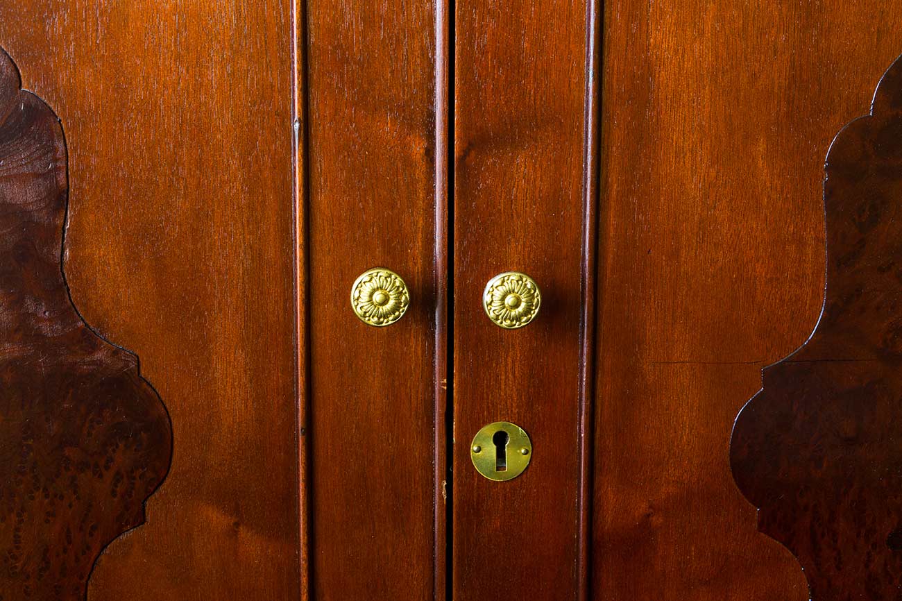 Brass knobs on an antique armoire or wardrobe.