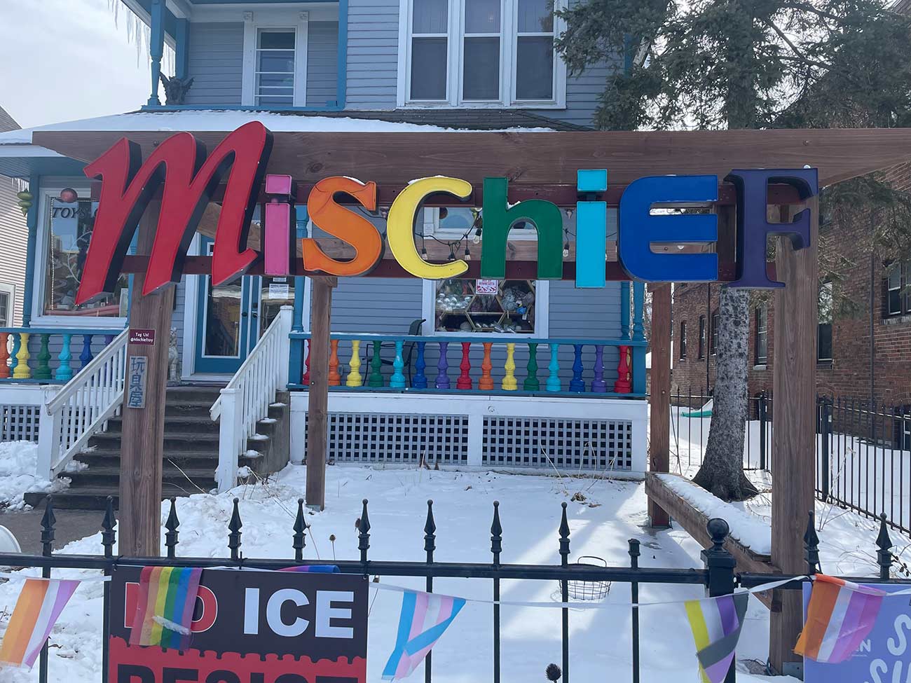 The exterior entry of the Mischief toy store featuring their colorful lettered sign.