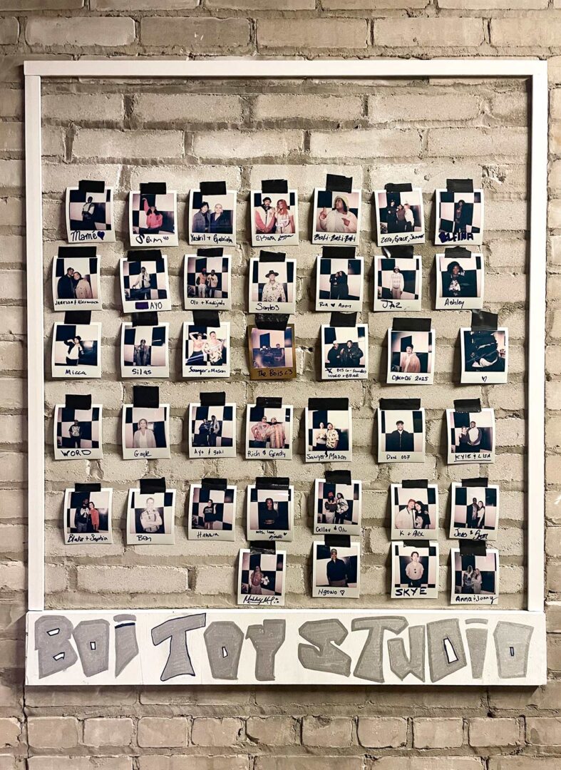 The BOI TOY Studio photo wall with multiple Polaroid photos hanging.