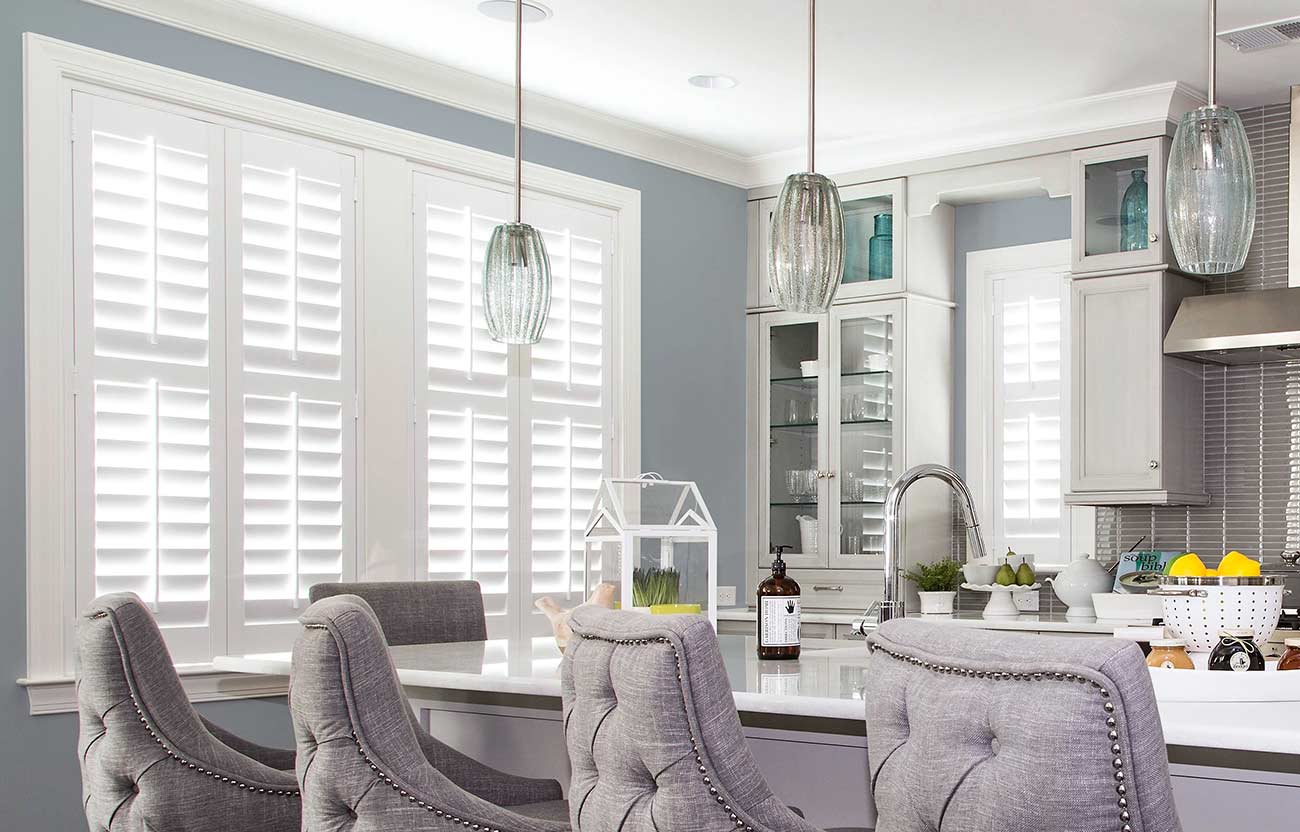 Modern kitchen showcasing white window shutters.