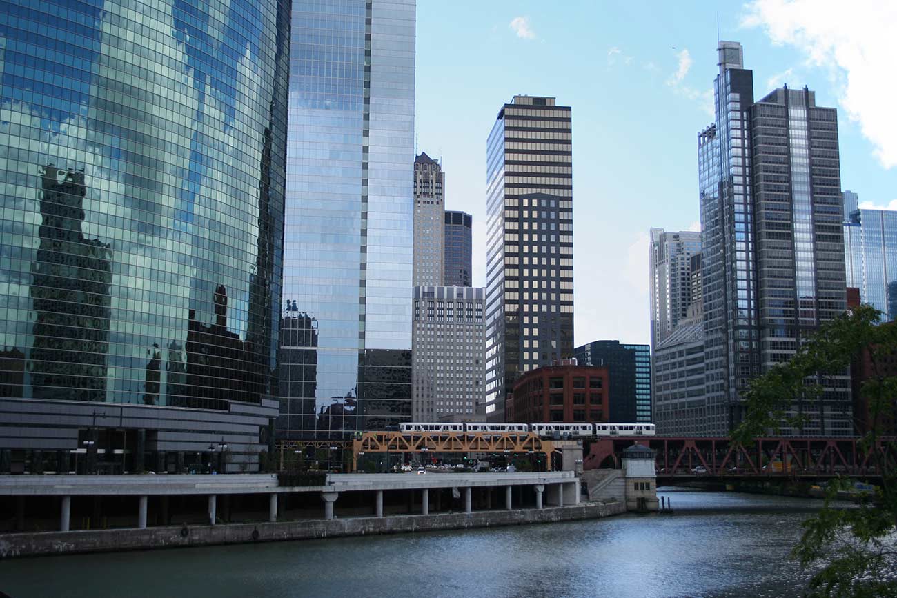 El train crossing bridge and Chicago skyline.