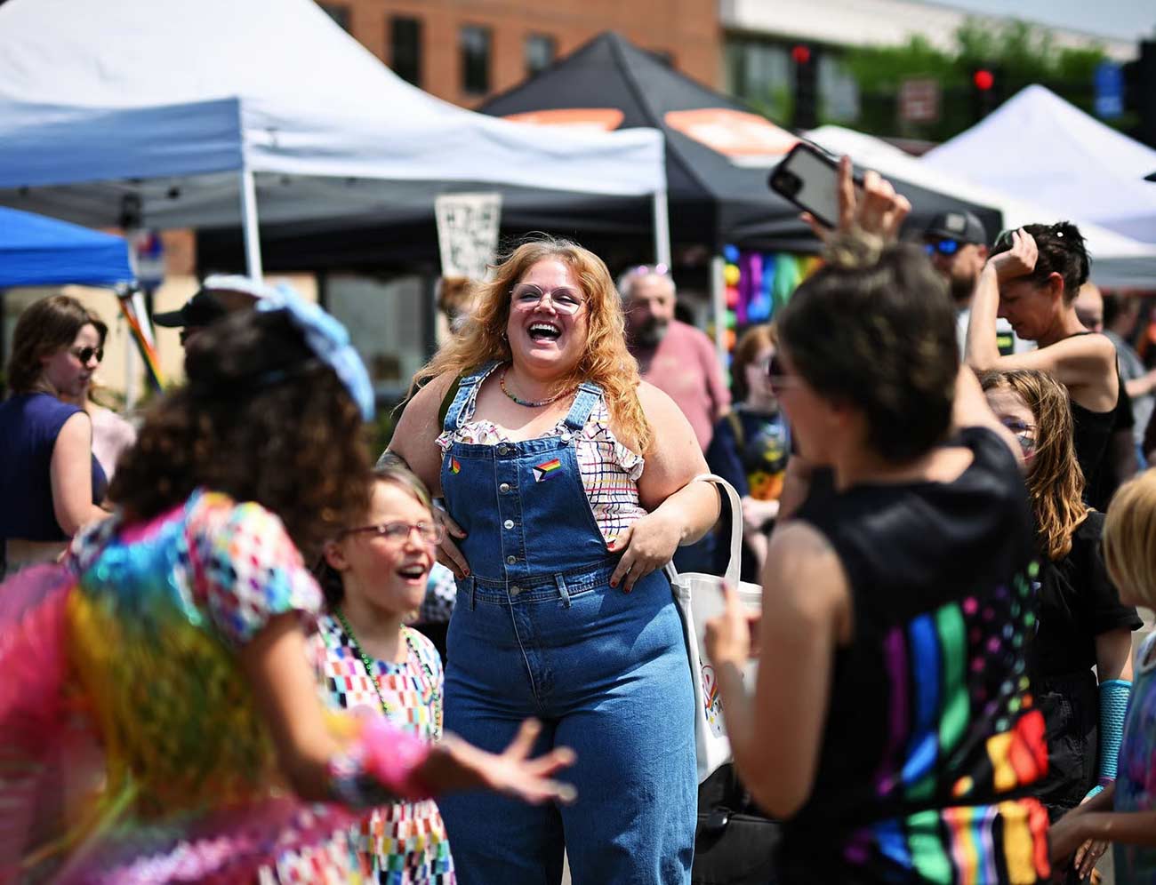 Happy people in a crowd at Anoka Pride festival.