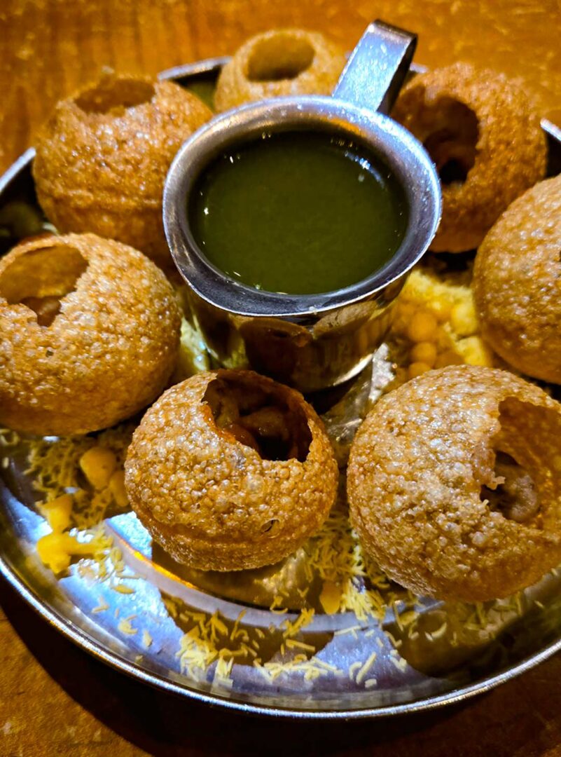 A plate with Gol Guppa Shots at Chauhan Ale & Masala House.