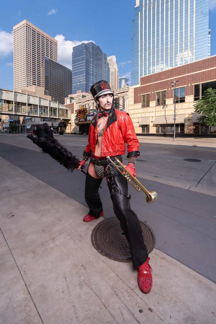 Drag king Dick Von Dyke poses in a leather outfit for a photo on the street in Minneapolis.