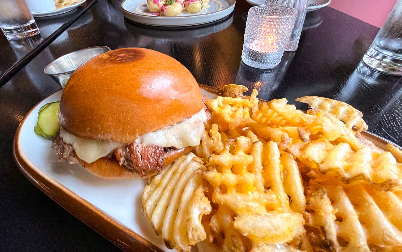Duck burger cooked Oklahoma onion style with mustard pickles, havarti cheese served with waffle fries.