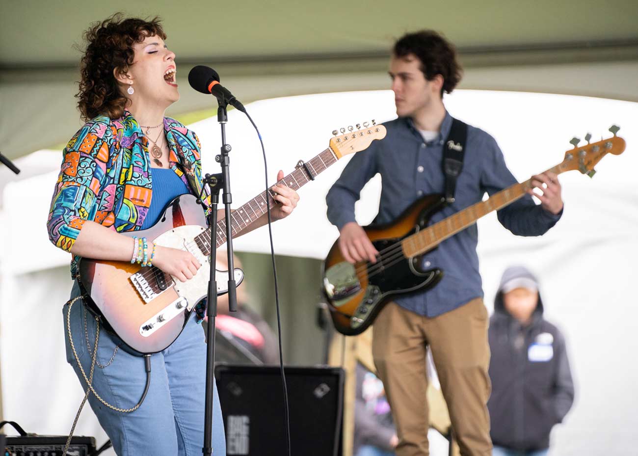 Local Rochester singer on stage with her band mate playing guitars.